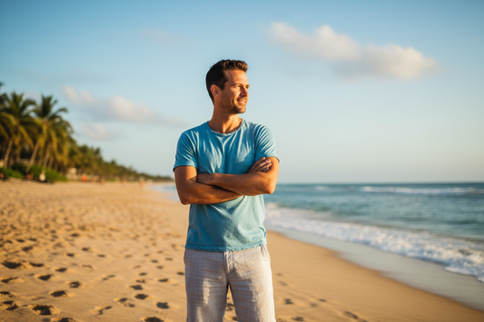 Man in his 30s on a beach wearing a t-shirt